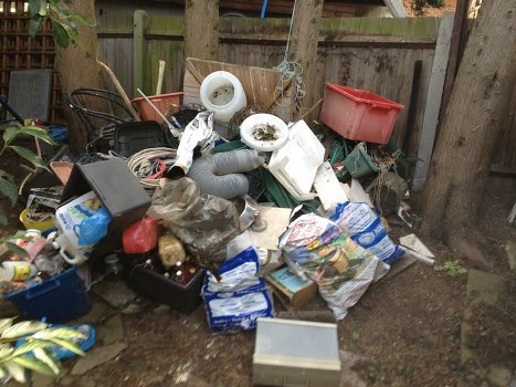 Worker placing labeled boxes during an accessible house clearance operation in Esher
